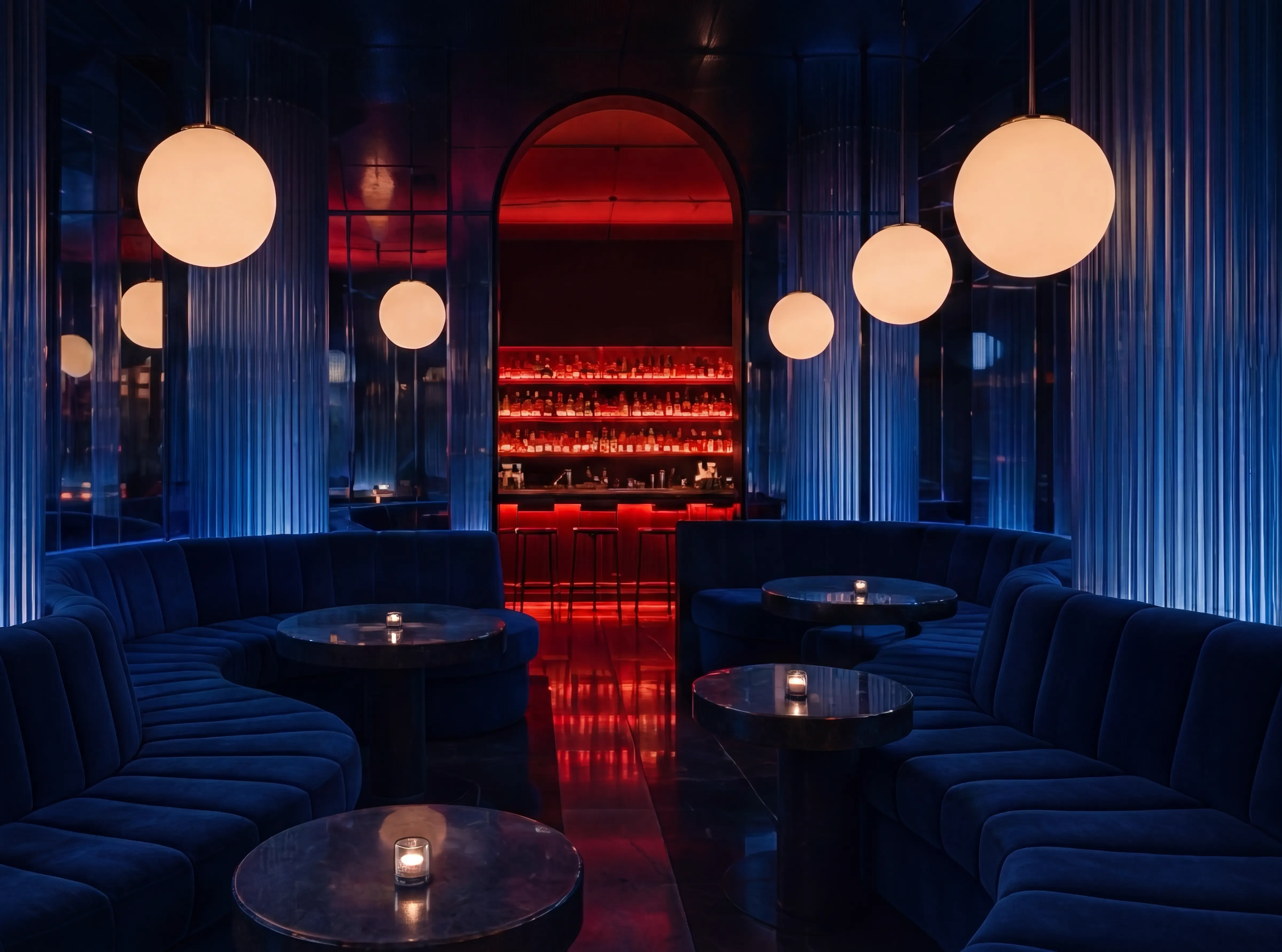 The room at Mujize: cobalt velvet booths under opal globe lamps, a crimson-lit arch of bottles at the back.